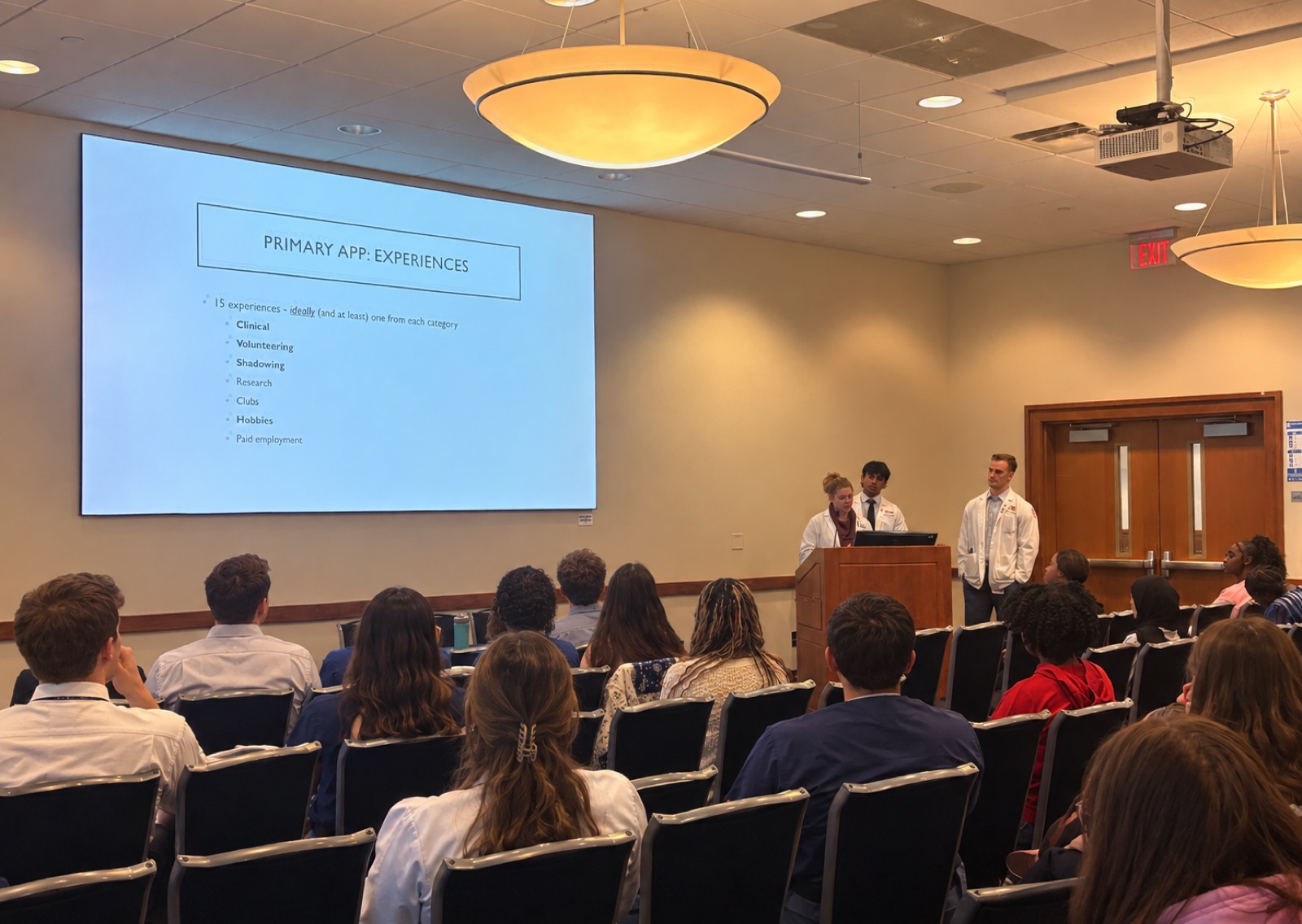 MedRise mentors presenting on the medical school application process to a seated audience at the University of Memphis